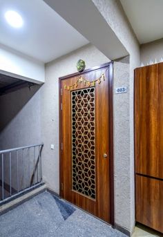 two wooden doors are next to each other on the stairs in front of a building