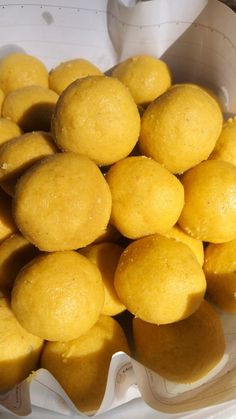 a basket filled with yellow donuts sitting on top of a table