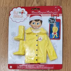 a plastic doll wearing a yellow raincoat