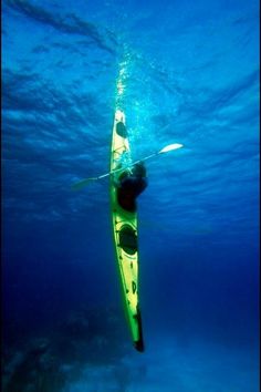 a man is paddling his kayak under the water