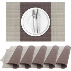 four placemats and one plate with silverware on it, next to a set of three place mats