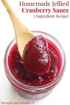 homemade jellied cranberry sauce recipe in a jar with a wooden spoon