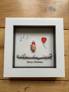 two birds are sitting on a branch with music notes in the background, framed in a white frame