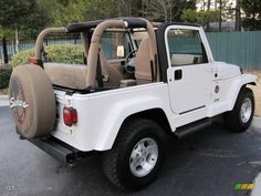 a white jeep parked in a parking lot