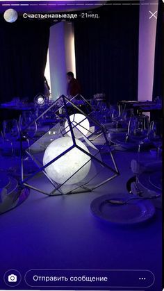 a room filled with lots of tables covered in plates and wine glasses on top of them