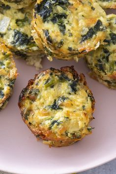 small muffins with spinach and cheese are on a pink plate, ready to be eaten