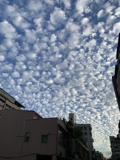 the sky is filled with clouds over buildings