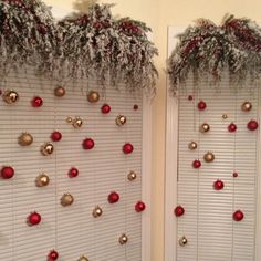 two white shutters decorated with red and gold ornaments