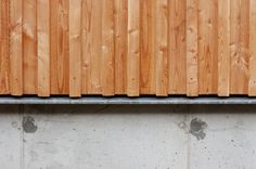 a close up view of a wooden roof on a building with concrete and wood slats