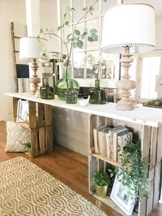 a living room filled with lots of furniture and plants on top of a wooden table