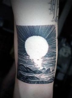 a man's arm with a black and white tattoo on it, depicting an image of a hot air balloon in the sky