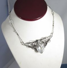 "Sometimes you need a lot of sparkle in something that can complement anything from a wedding gown to a fun top for a night on the town...this is that piece! It features a large and sparkly quartz briolette wrapped into an elegant triangle of sterling and fine silver. Classy swirls have been wrapped together with fine gauge wire. The metal was then oxidized and polished to a shine to really emphasize the contrast in textures. The sterling silver chain is dotted with white topaz. This pendant is Ice Crown, Crown Necklace, Handmade Wire Jewelry, Copper And Brass, Handmade Wire, Necklace Sterling Silver, The Ice, White Topaz, Sterling Silver Chain