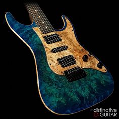 an electric guitar that is made out of wood and blue watercolors on the body