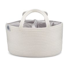 a large white basket with handles on the front and sides, filled with fabric material