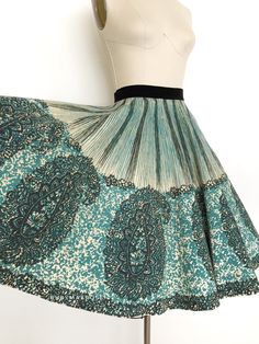 "vintage skirt  Era: 1950's Label: Bobbie Brooks Material: felted wool and velvet Closure: side metal zipper, button waist  Colour: blue, black, cream  Details: gorgeous large scale border block print of a paisley pattern, true circle skirt Fits like: xsmall Waist: 23\" Hips: free Length: 26\" Condition: There are a couple small holes on the inside which don't show through. Couple of tiny spots. Discolouration to the inside side seam. Repair behind the button waist closure. May need a dry clean to freshen it up.  Priced accordingly.  shop policy  * All items are a final sale. No returns, exchanges and, order cancellations are not accepted.  * Ruby Mae Rose is not responsible for lost or stolen parcel(s) and any duty, import, VAT charges that are determined by the receiving country. Ruby Ma 1950s Circle Skirt, Ruby Mae, 1950s Skirt, Gored Skirt, Bobbie Brooks, Wool Winter, Winter Skirt, 50s Vintage, Skirt Fits