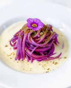 a white plate topped with purple food and garnish