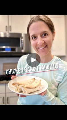 a woman is holding a plate with food on it and the words chicken ranch tauitos are in front of her