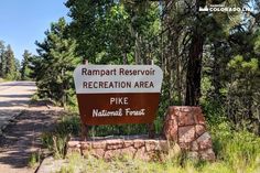 there is a sign in front of the road that says rampart reservoir recreation area