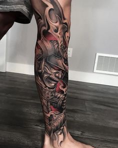 a man's leg with tattoos on it