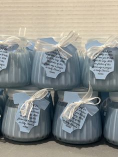 several blue candles with tags on them sitting in front of a cardboard box