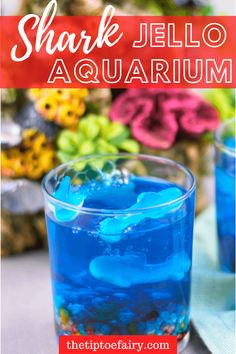 a blue liquid in a glass with the words shark jello aquarium on top and below it