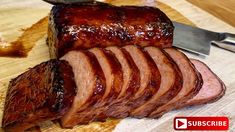 sliced meat sitting on top of a cutting board next to a knife