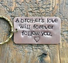 a metal keychain that says, abrother's love will forever follow you