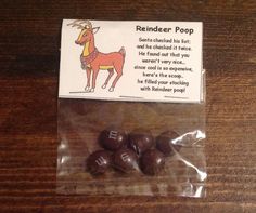 some kind of chocolate candies in a bag on a wooden table with a note about reindeer poop