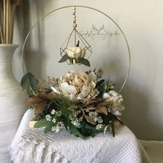 a white flower arrangement sitting on top of a table