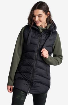 Take on the between season with a hooded vest cut to a longer length for extra warmth. 30" length (size Medium) Front zip closure Drawstring hood Front zip pockets Lined, with recycled-polyester fill 100% nylon Machine wash, line dry Imported Down Winter Coats, Lightweight Vest, Spring Coat, Winter Parka, Fit Back, Hooded Vest, Long Vests, Quilted Vest, Down Vest