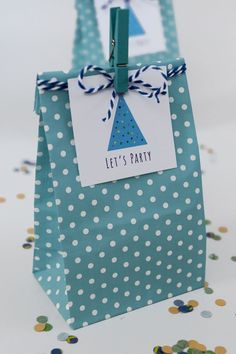 a party bag with a blue and white polka dot design