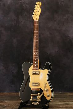 an electric guitar sitting on top of a wooden table