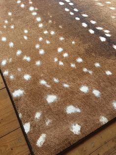 a brown rug with white spots on it