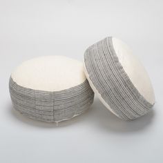 two round pillows sitting on top of each other