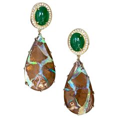 Drop dangle earrings of oval cabochon tsavorites surrounded by diamond pave, with pear shaped boulder opal drops, handcrafted in 18 karat yellow gold. These one-of-a-kind earrings of gorgeous tsavorites, boulder opals and diamonds reflect the natural beauty of Mother Earth's colors and intrinsic beauty. The vivid green blue veins of the opals are so vibrant in contrast to the brown background opal color, and they truly sparkle in the light! The beautiful green hues of the tsavorites also bring out the vivid greens in the opals. These luxurious earrings bring a touch of natural elegant style to every look! Blue Veins, Koroit Opal, Pink Opal Earrings, Rose Gold Drop Earrings, Dope Jewelry Accessories, Opal Drop Earrings, Sapphire And Diamond Earrings, Sparkly Jewelry, Luxury Earrings