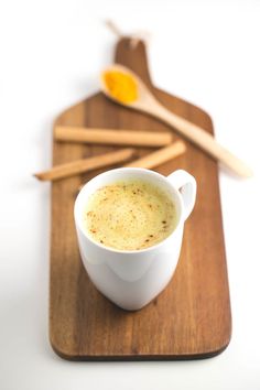 a cup of coffee sitting on top of a wooden tray