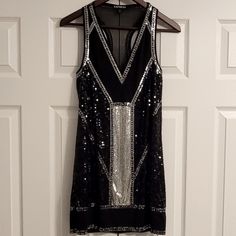 Brand: Express Size: Women's Xs Color: Black And Silver Material: 100% Polyester Lining: 100% Polyester Care: Hand Wash Cold Fun Party/Cocktail Dress! Brand New Without Tags. Msrp: $108.00 Sheer Chiffon Fabric With Black And Silver Sequins. This Is Fully Lined Inside. Sleeveless Arms With A V-Neck Front Give This A Sexy Piece A Modern Style And Look. Fitted Sleeveless Silver Sequin Dress, Silver Sleeveless Sequin Cocktail Dress, Silver Sleeveless Mini Dress For Night Out, Silver Sleeveless Sequin Dress For Night Out, Silver Sleeveless Sequin Dress For Date Night, Silver Sleeveless Dress For Date Night, Fur Purse, Party Cocktail Dress, Roaring 20s