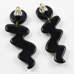 This is part of Chairish’s Costume Jewelry assortment.  Impressive Italian Lucite dangling clip-on earrings. Oversized zig-zag shape in true licorice black color with gilded heart and bead inclusions. There is no visible maker's mark. Measurements: 3.63 in long (9.2 cm) x 1.19 in wide (3 cm).  Please see the measurements noted above in the description for the best approximate dimensions. Black Clip-on Earrings For Gift, Black Clip-on Earrings As Gift, Black Retro Clip-on Jewelry, Black Tears, Accessories Jewelry Earrings, Clip Earrings, Licorice, Makers Mark, Costume Jewelry