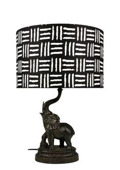 an elephant lamp with a black and white shade