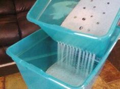 a large blue plastic container sitting on top of a tiled floor