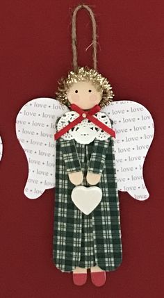 an ornament made to look like a angel with wings and a heart on it