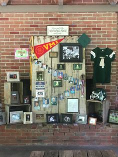 a wall covered in pictures and memorabilia next to a brick wall with photos on it