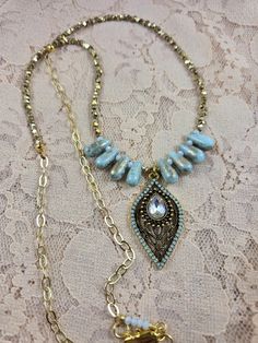 This elegant statement necklace makes a nice gift for a birthday, anniversary, the holidays or for any special occasion or for a night out on the town! It can be worn all year round. It is designed with pale turquoise and gold glass teardrop beads, gold shiny metal beads, a gold chain and lobster claw clasp, and a color coordinated pale turquoise, crystal and gold plated teardrop pendant. The drop length is 14 inches.  If you look through my earring and bracelet collection you should be able to find pieces designed with the same beads to create a matching jewelry set if they are still available. Gold Teardrop Crystal Necklaces With Adjustable Chain, Gold Teardrop Crystal Necklace With Adjustable Chain, Elegant Beaded Teardrop Pendant Crystal Necklace, Bohemian Gold Teardrop Pendant Drop Necklace, Gold Bohemian Teardrop Pendant Drop Necklace, Bohemian Gold Teardrop Pendant Necklace, Elegant Long Beaded Turquoise Necklace, Beaded Chain Teardrop Pendant Jewelry For Gift, Beaded Chain Jewelry With Teardrop Pendant For Gift