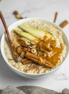 a bowl filled with oatmeal topped with apples and cinnamon