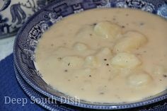 a blue and white bowl filled with soup