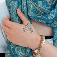 a woman's hand with a tattoo on it