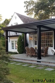 a covered patio area with chairs and tables