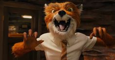 a man dressed as a fox with his hands in the air