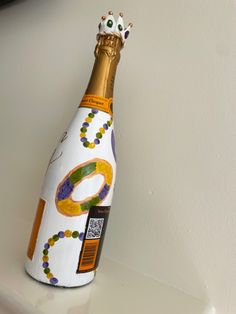 a wine bottle that is sitting on a shelf with a crown on top of it