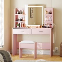 a pink vanity table with a mirror and stool